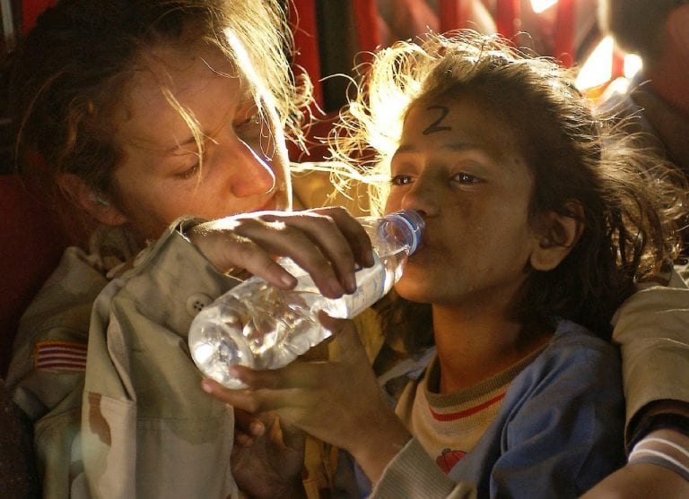 aid worker with child